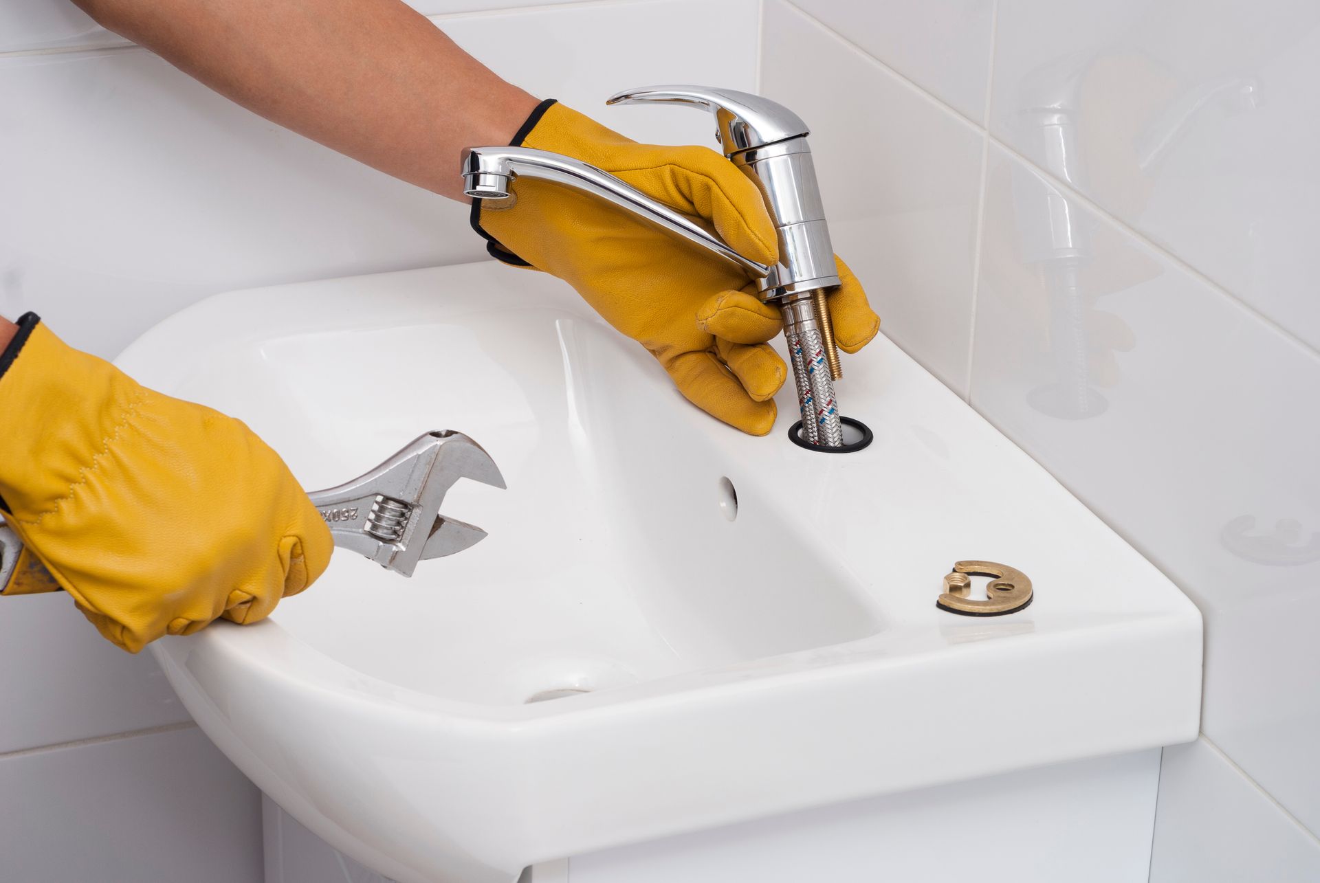 Professional plumber installing a sink near Bedford, TX.