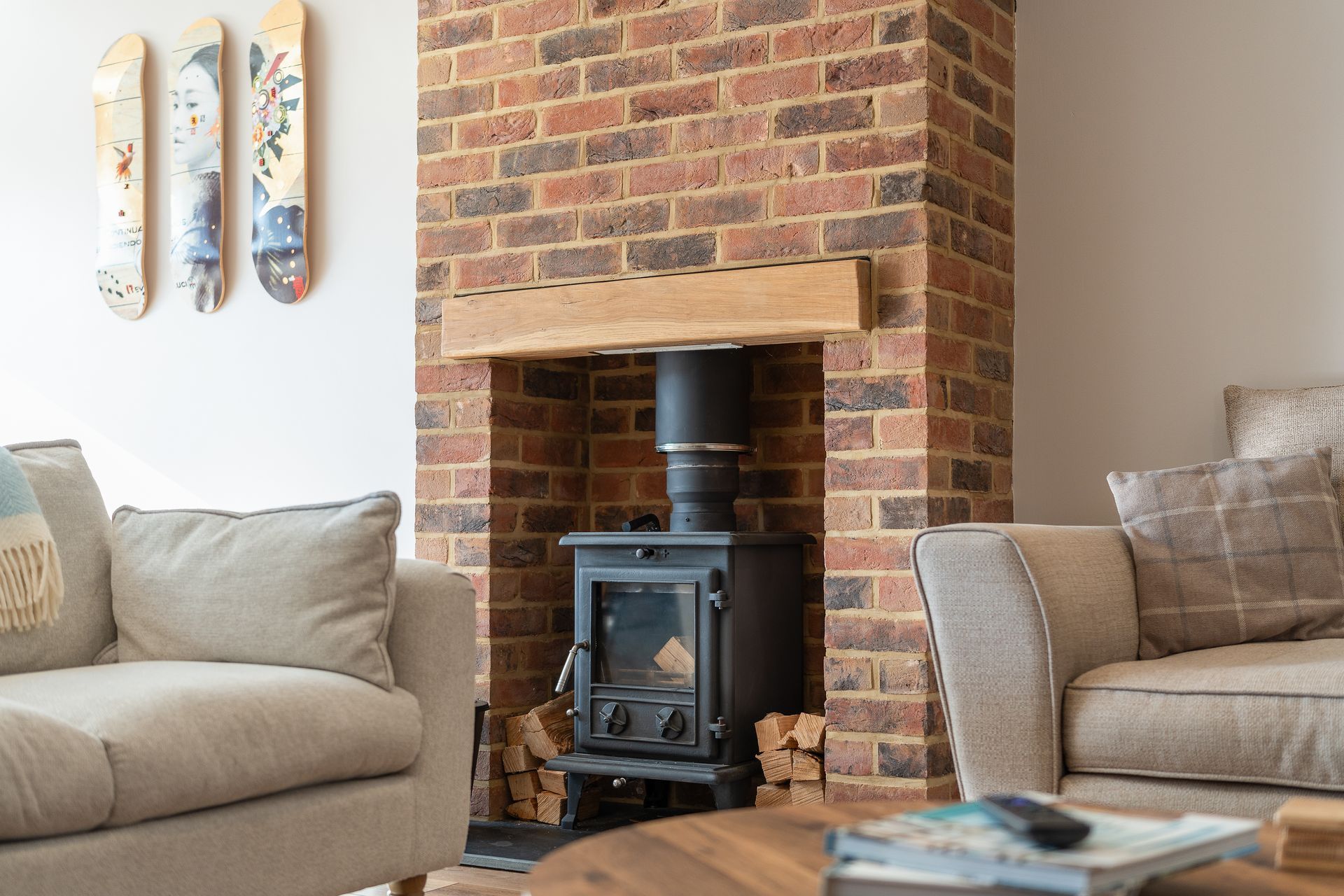 A living room with a brick fireplace and a wood stove.