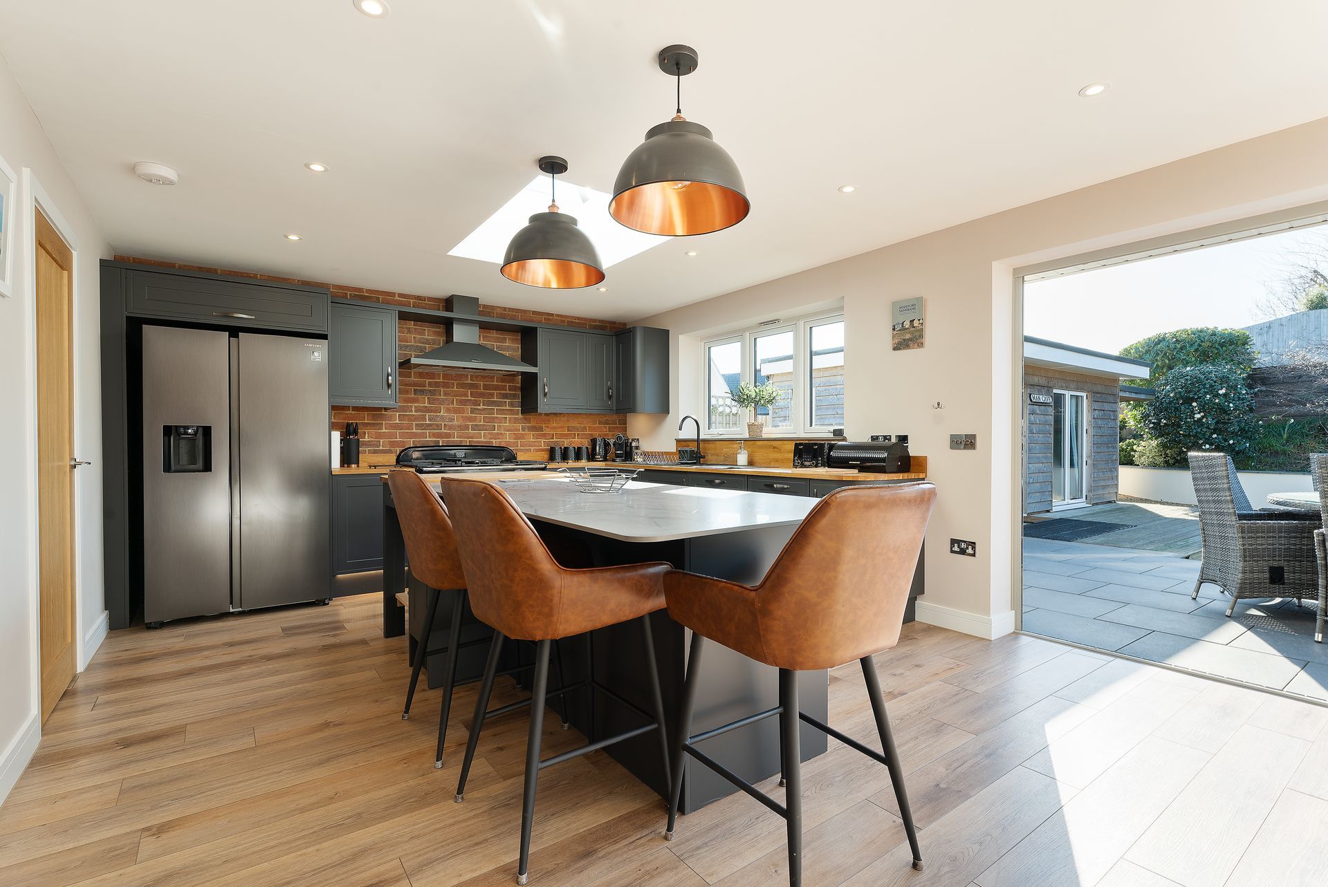 A kitchen with a table and chairs and a refrigerator.
