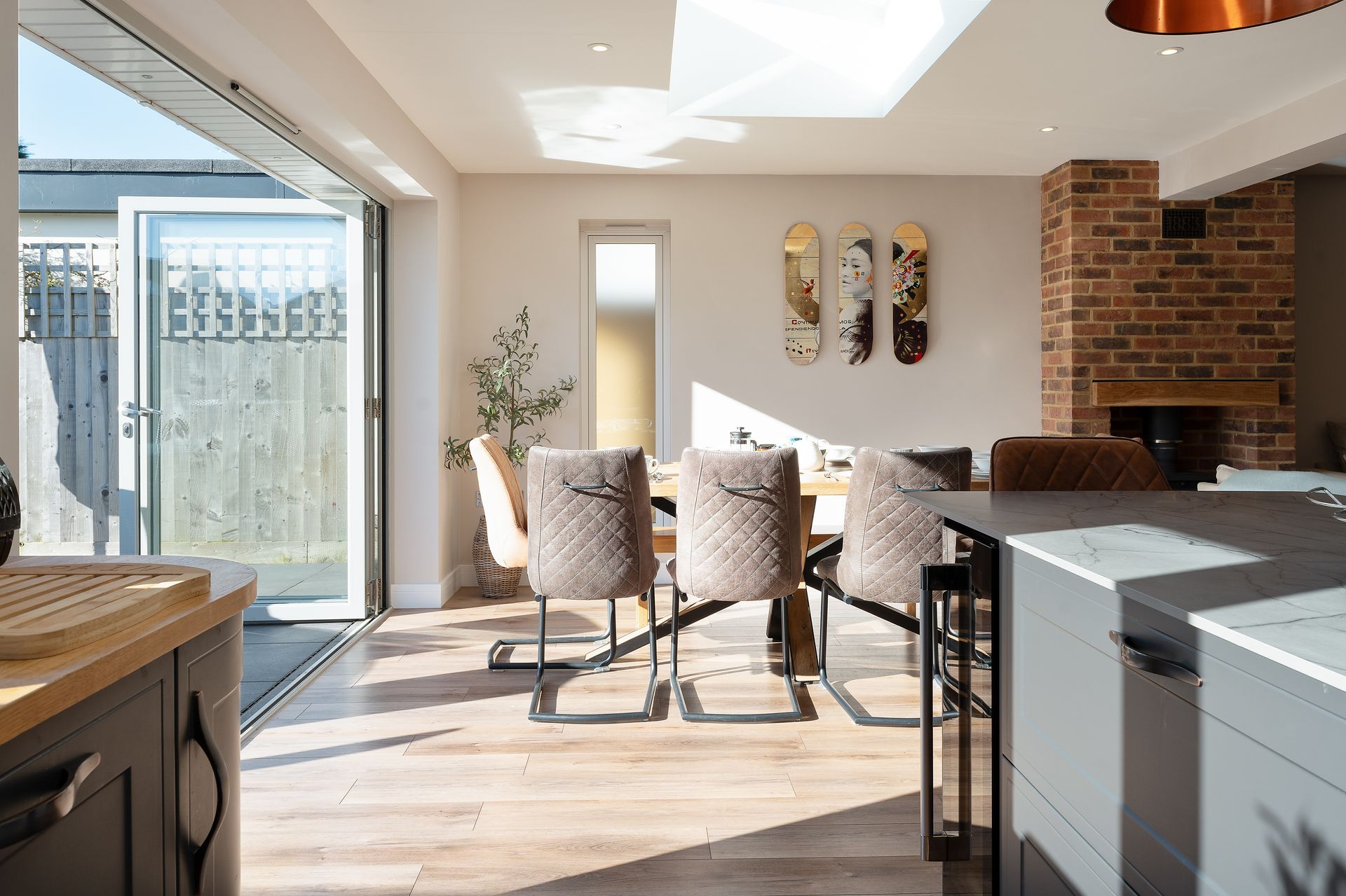 A kitchen and dining room in a house with a table and chairs.