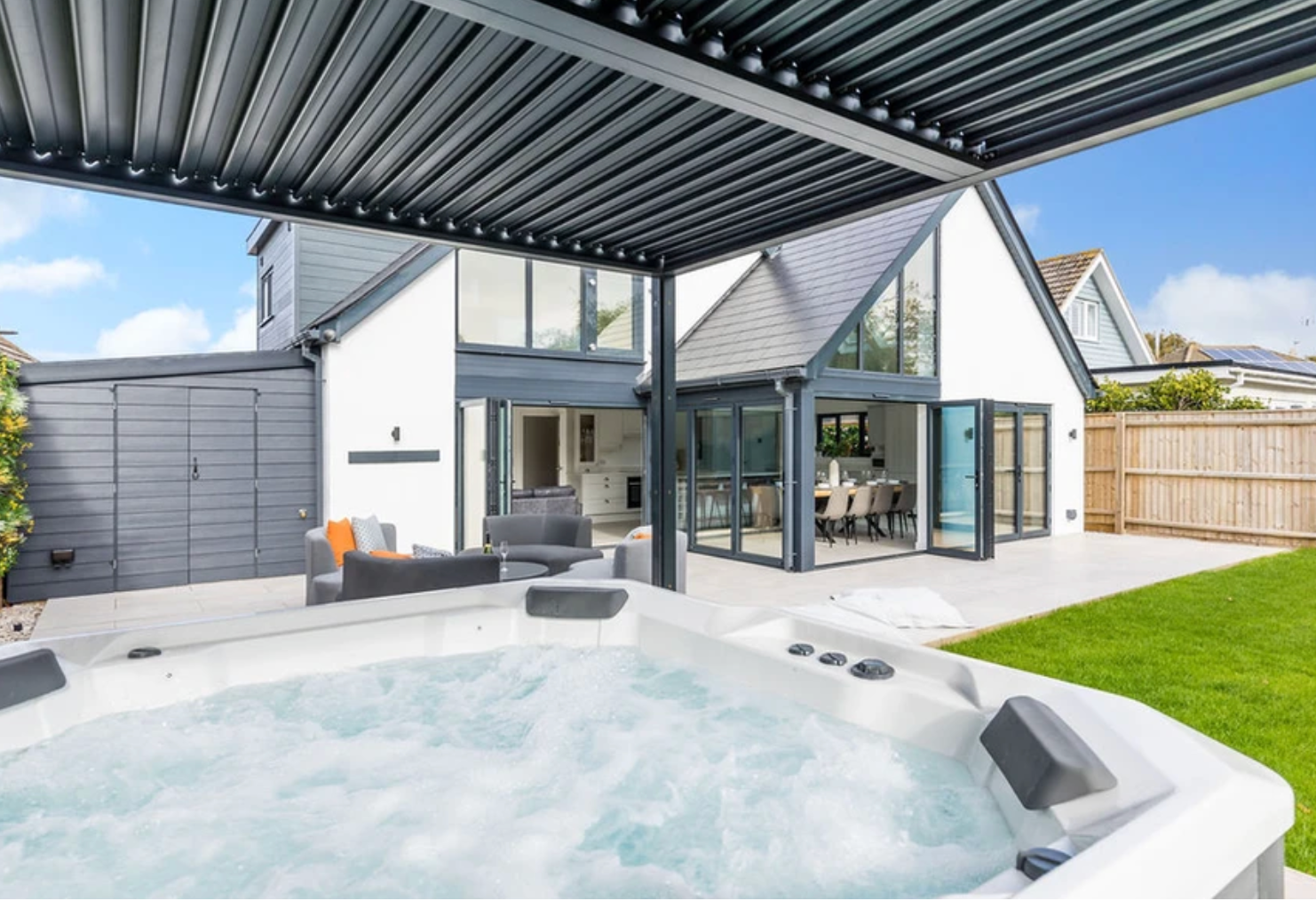A white house with a hot tub in front of it