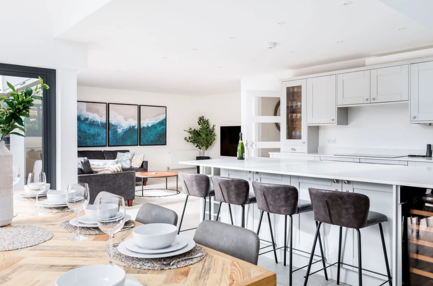 There is a dining table and chairs in the kitchen.