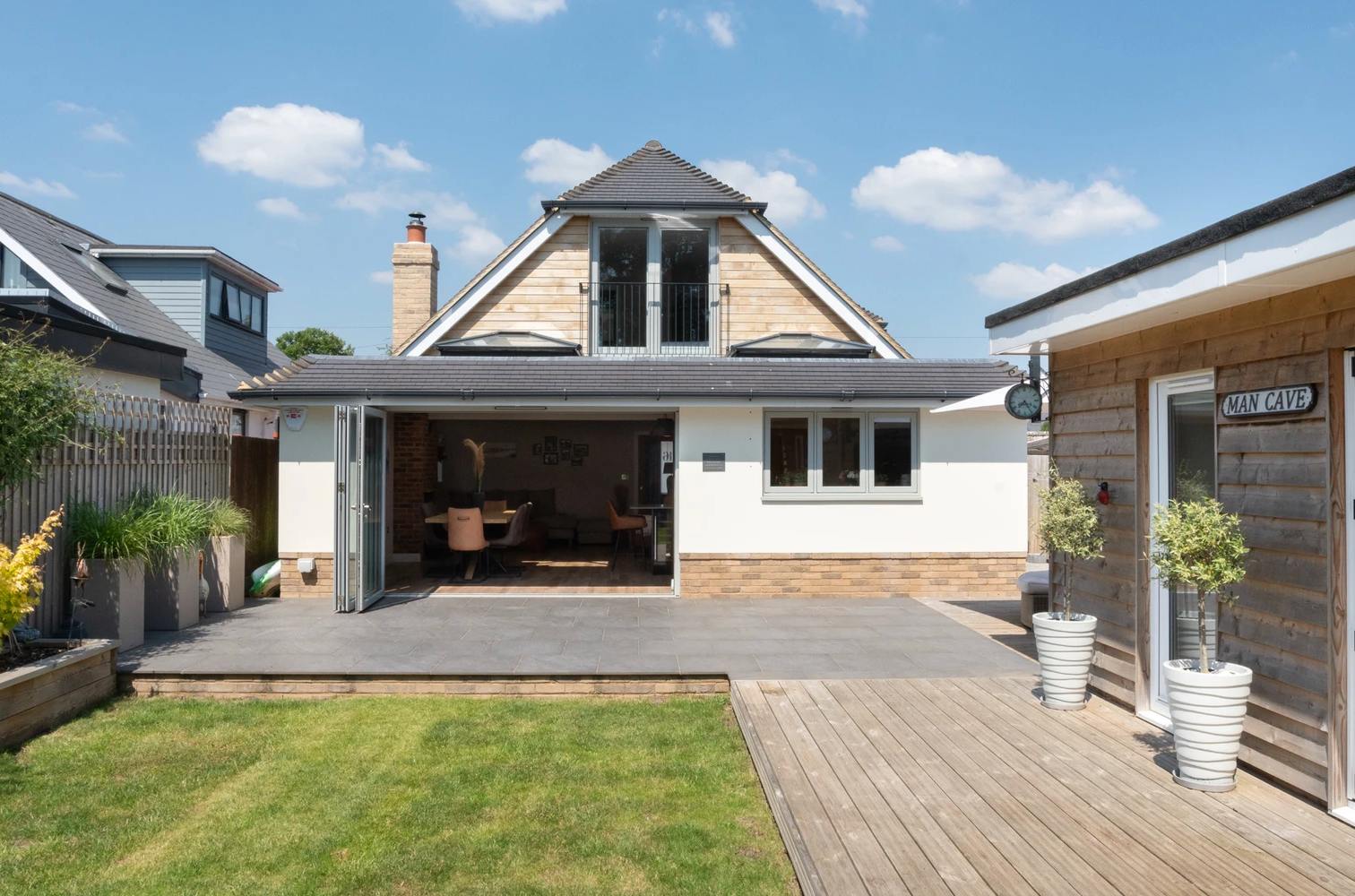 The back of a house with a large sliding glass door leading to a patio.