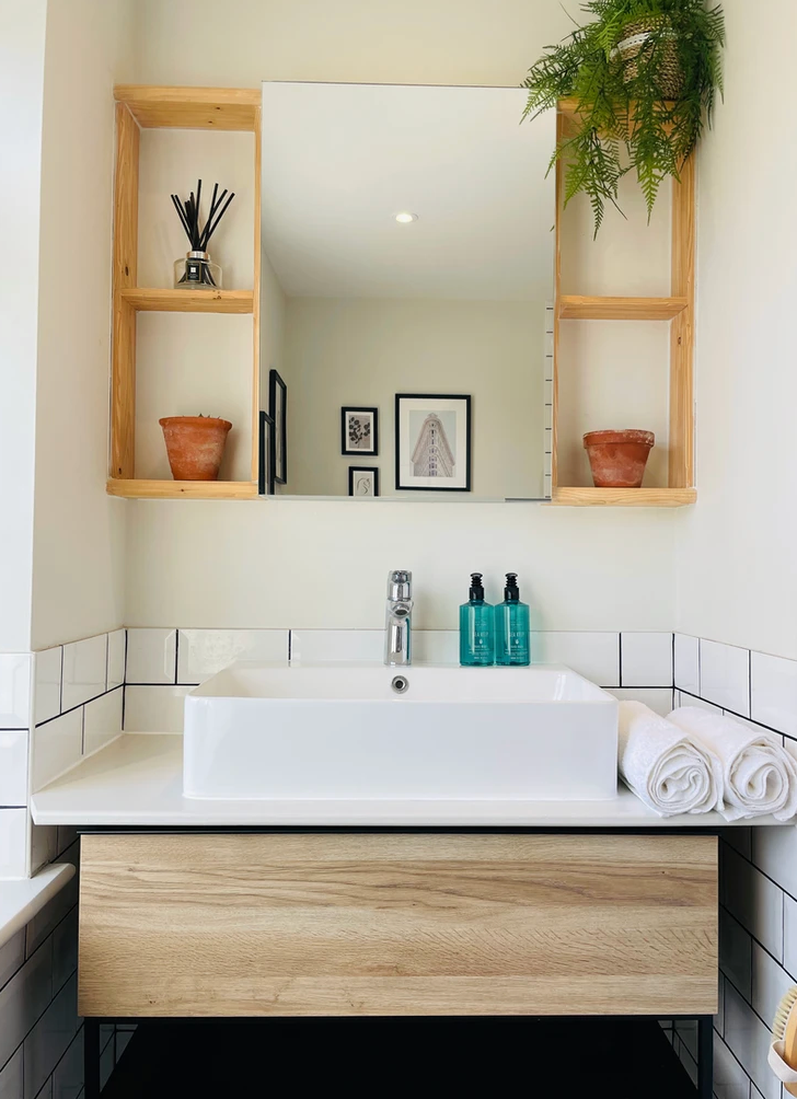 A bathroom with a sink and a mirror above it