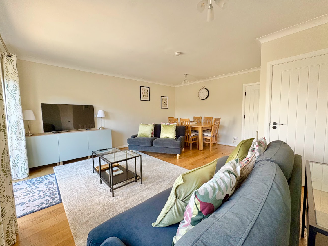 A living room with a couch , table and television.