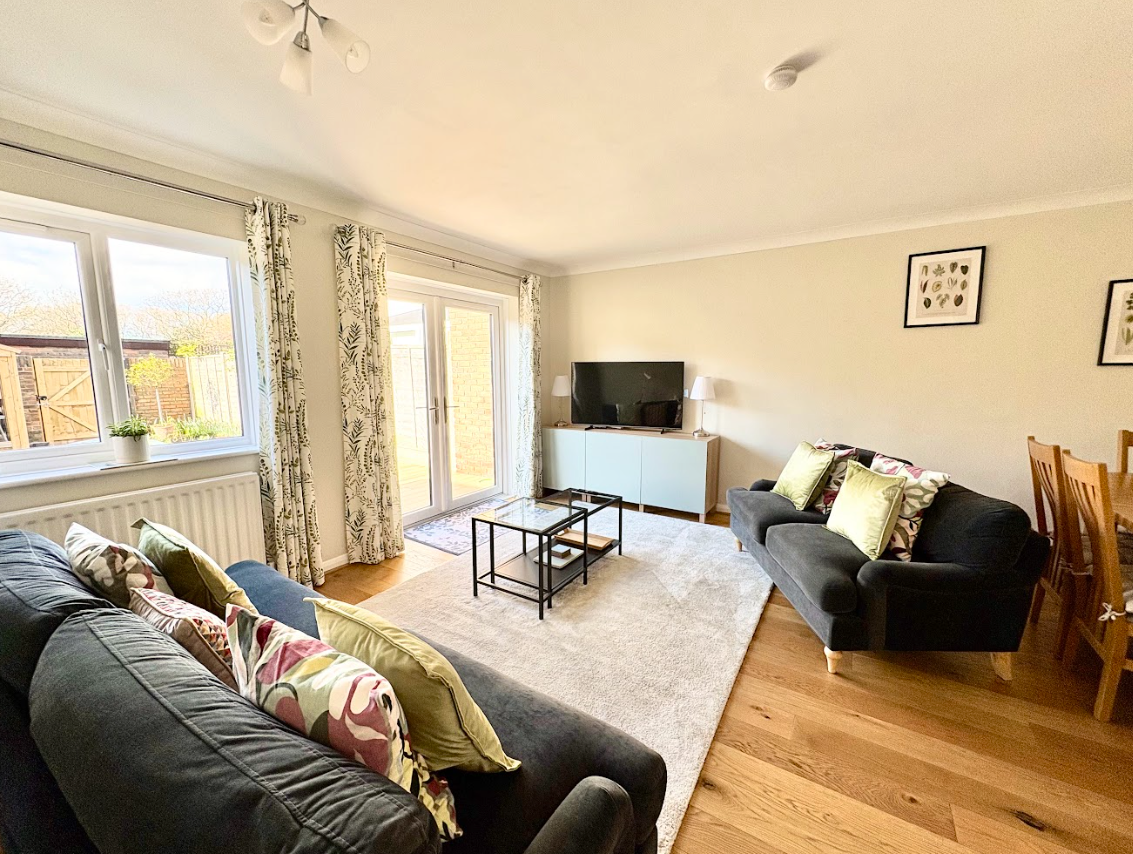 A living room filled with furniture and a flat screen tv.