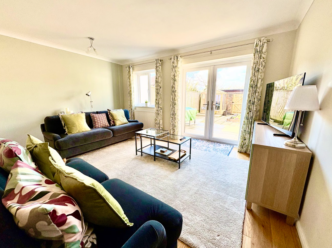 A living room with a couch , coffee table , and television.