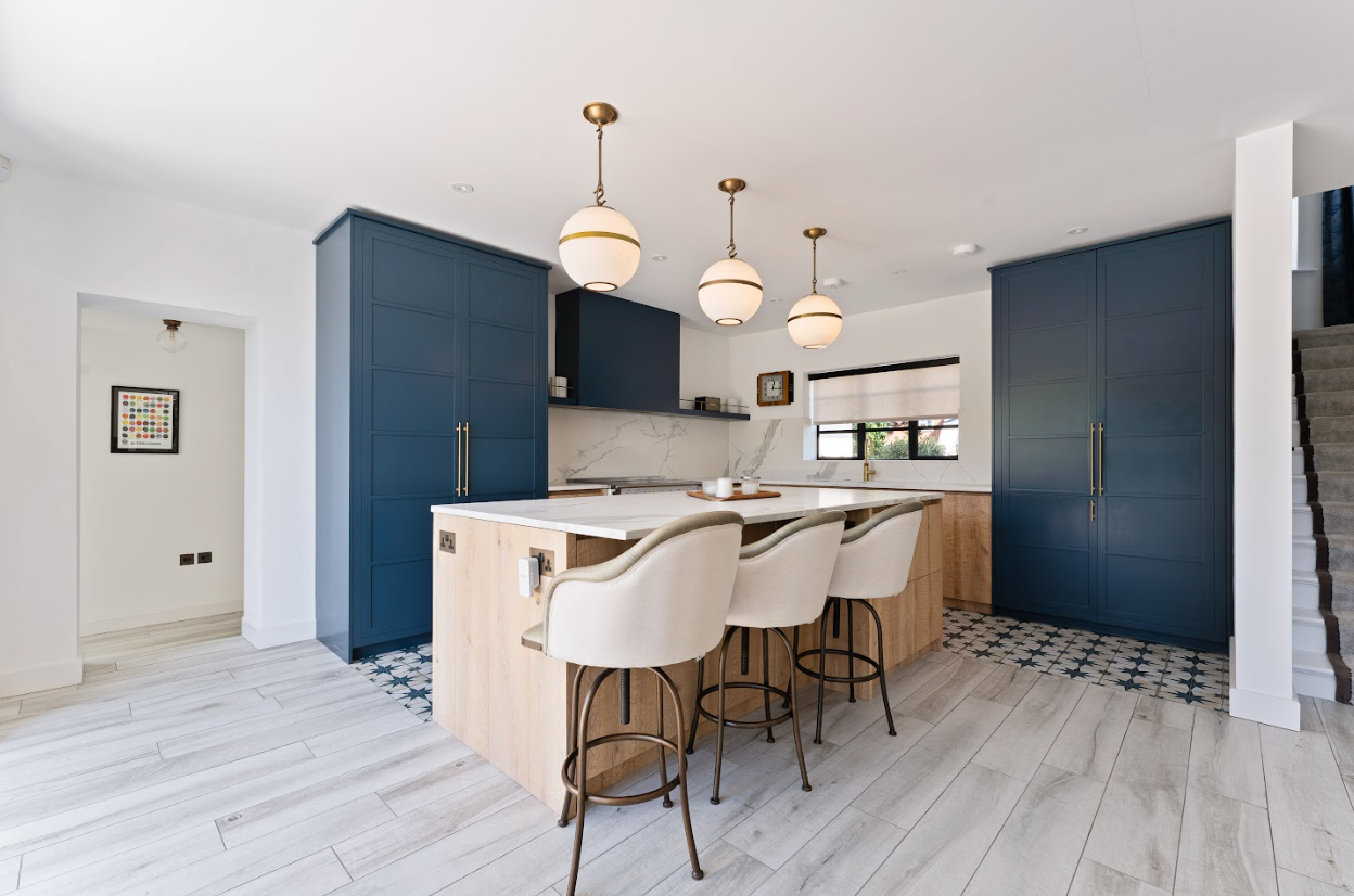 A kitchen with a large island and stools