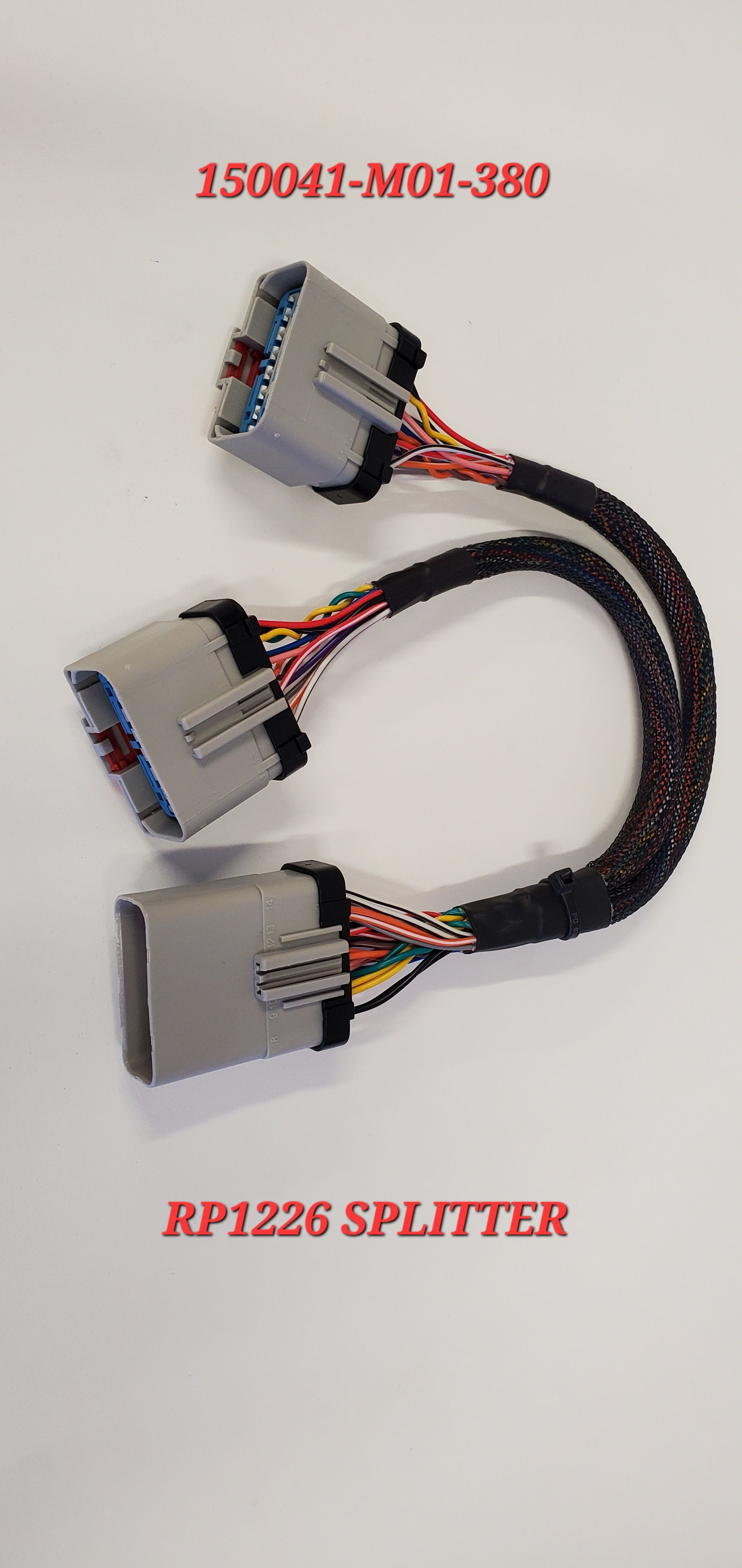 A couple of wires are connected to each other on a white surface.