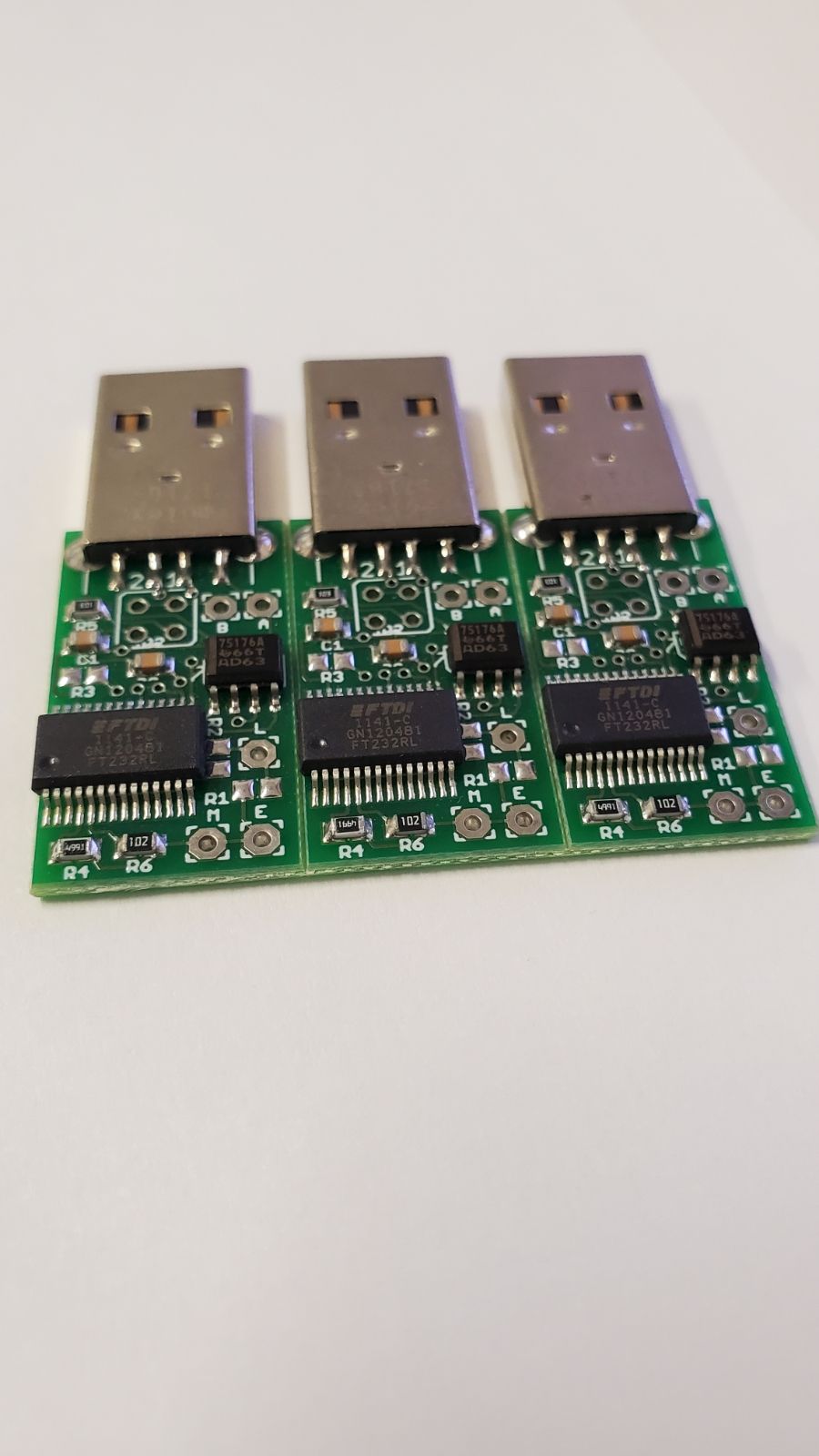 Three pieces of electronic equipment are sitting on top of each other on a white surface.