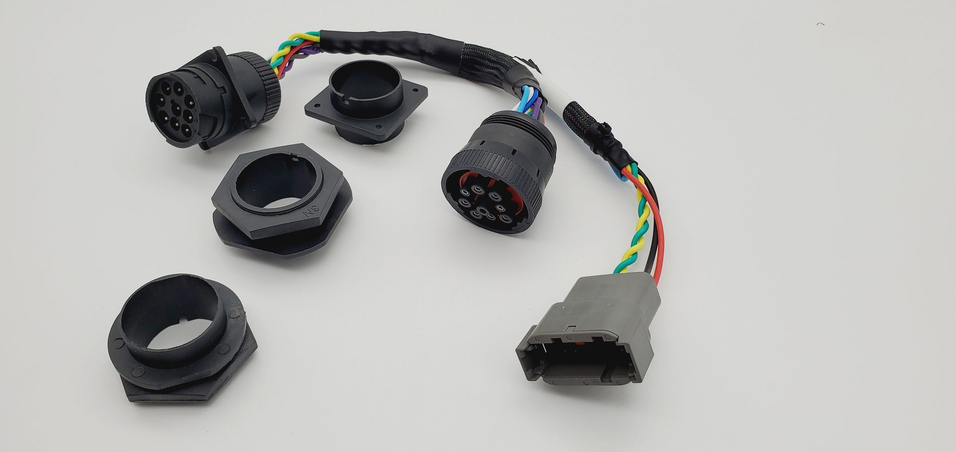 A bunch of wires are sitting on top of each other on a white surface.