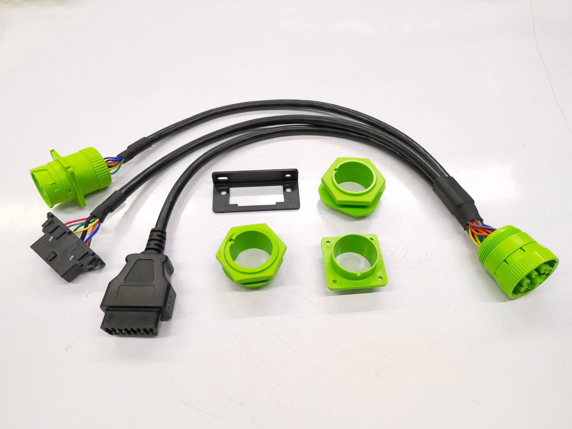 A bunch of green connectors and wires on a white surface.