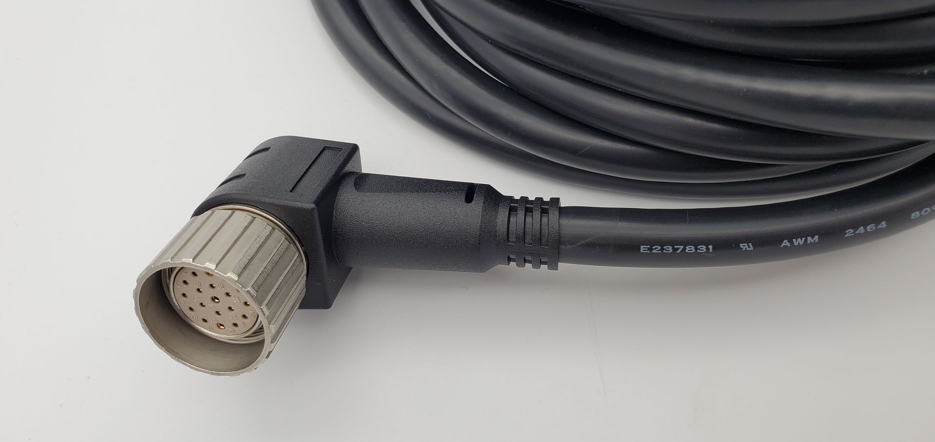 A close up of a cable with a connector on a white surface.