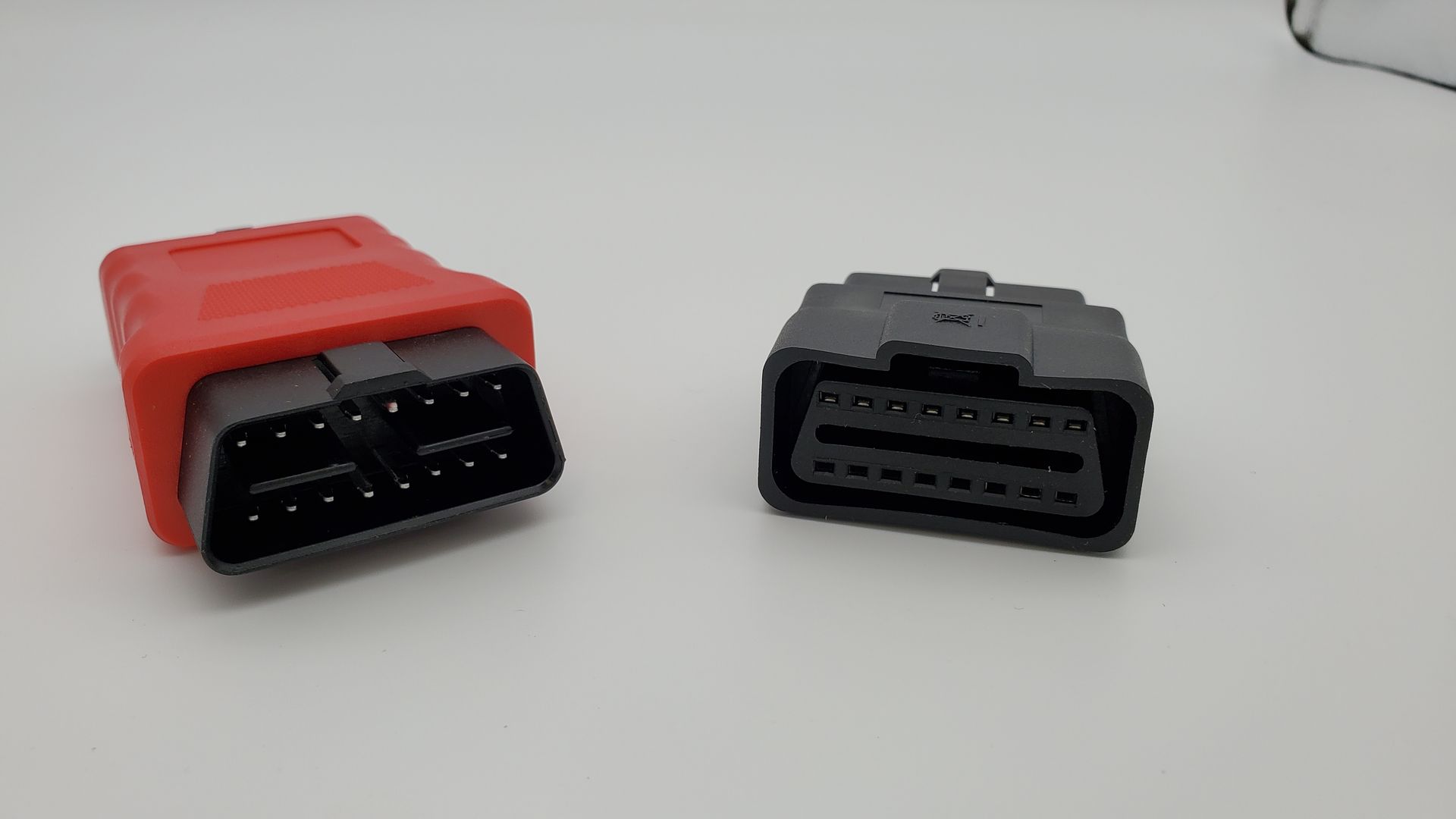 Two different types of connectors are sitting next to each other on a table.