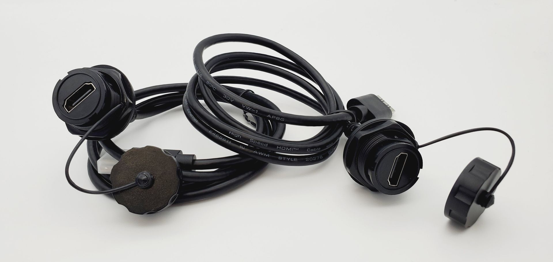 A bunch of black wires are laying on a white surface