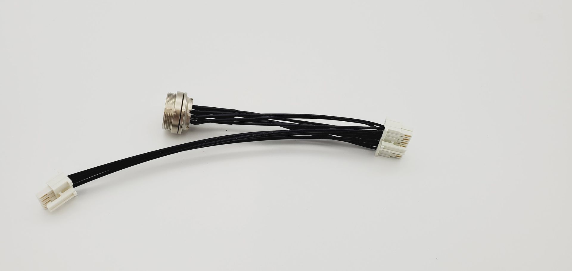 A close up of a black and white cable on a white surface.