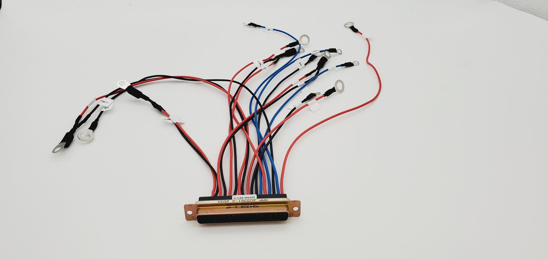 A bunch of wires are laying on a white surface.