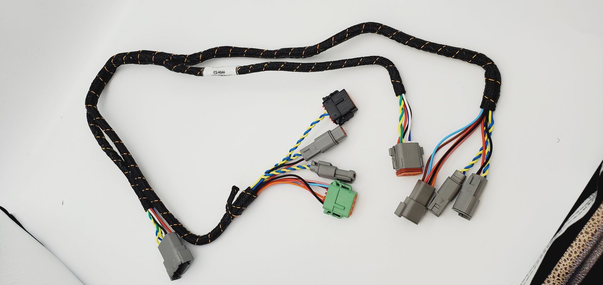 A bunch of wires are laying on a white surface.