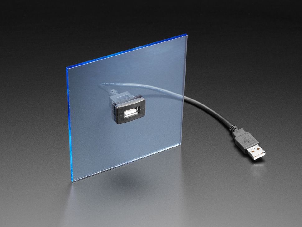 A usb cable is attached to a piece of glass.