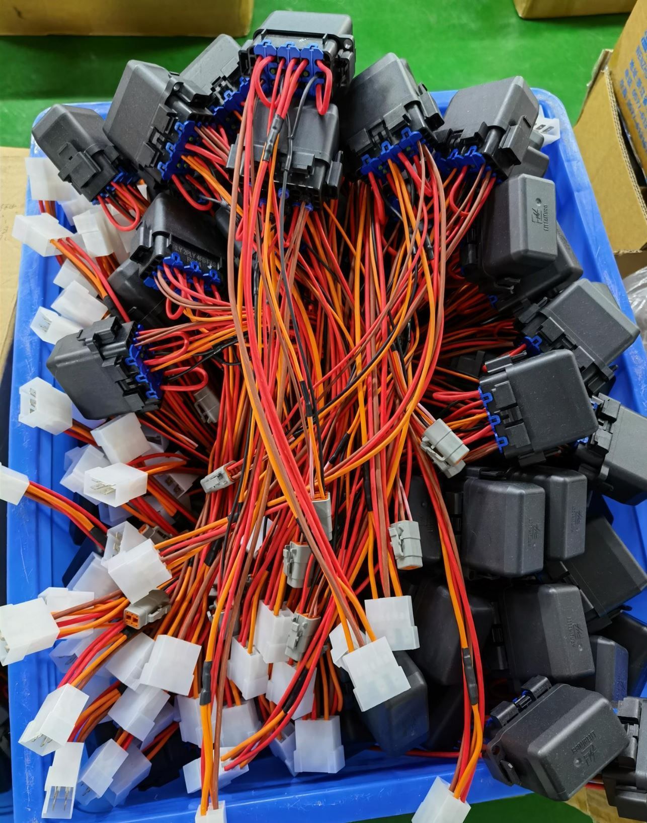 A blue container filled with lots of wires and connectors