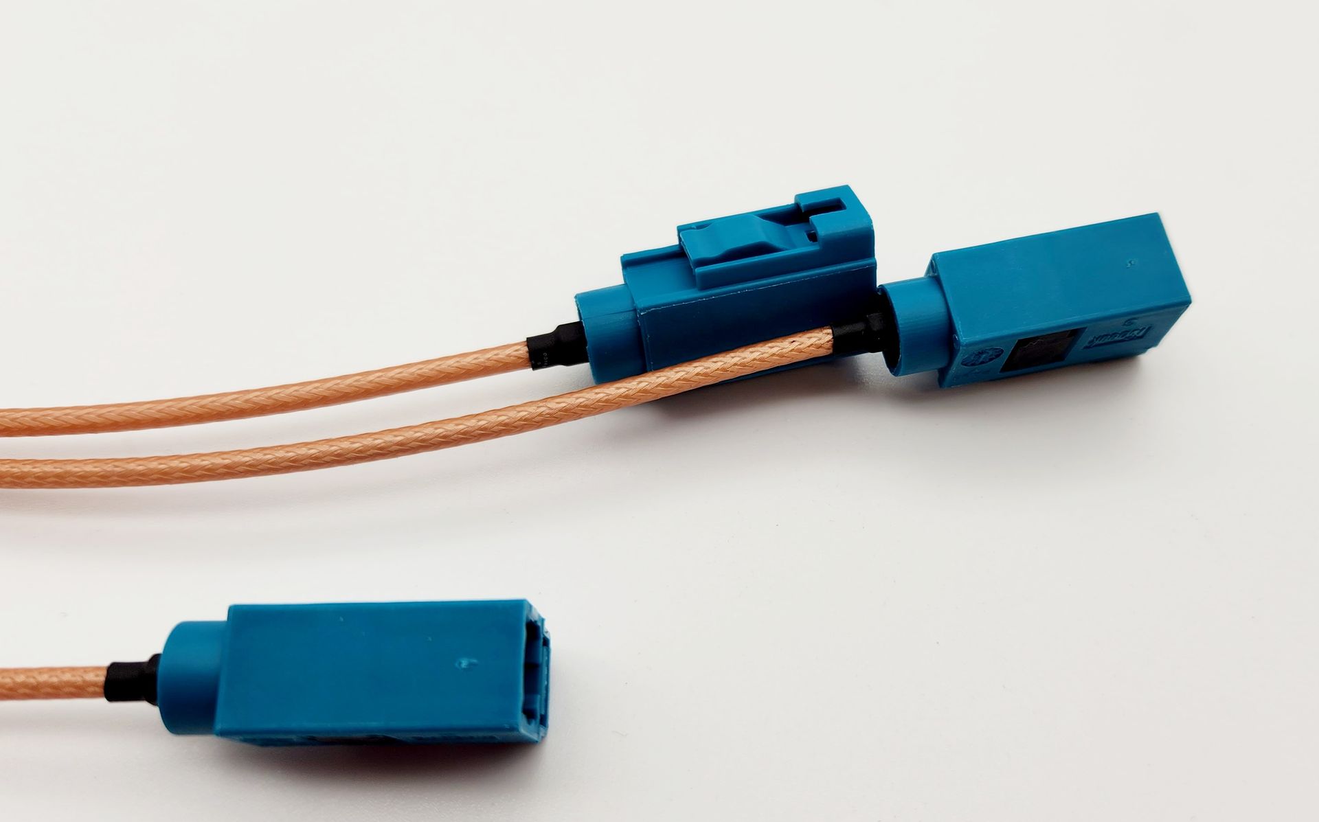 Two blue connectors are connected to each other on a white surface.
