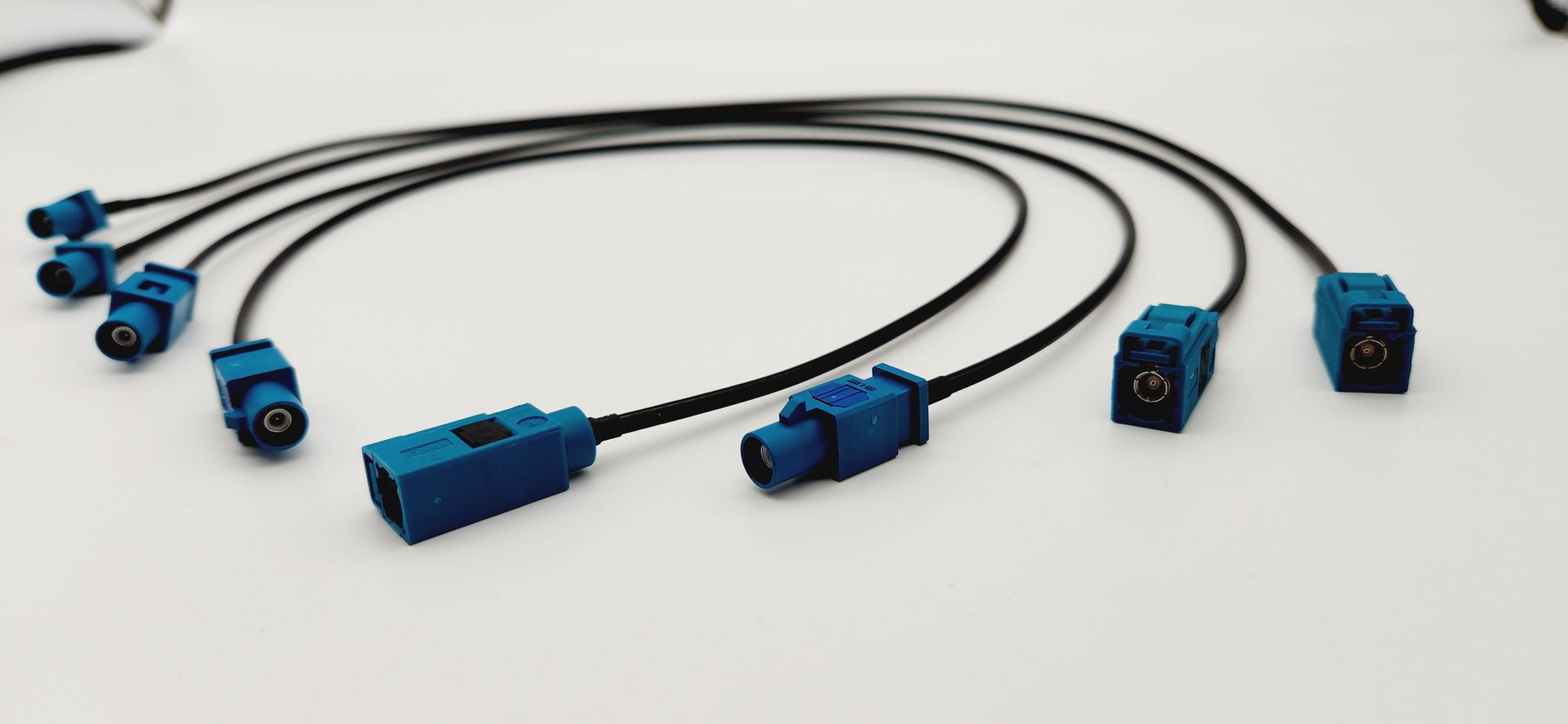 A bunch of blue and black wires are connected to each other on a white surface.