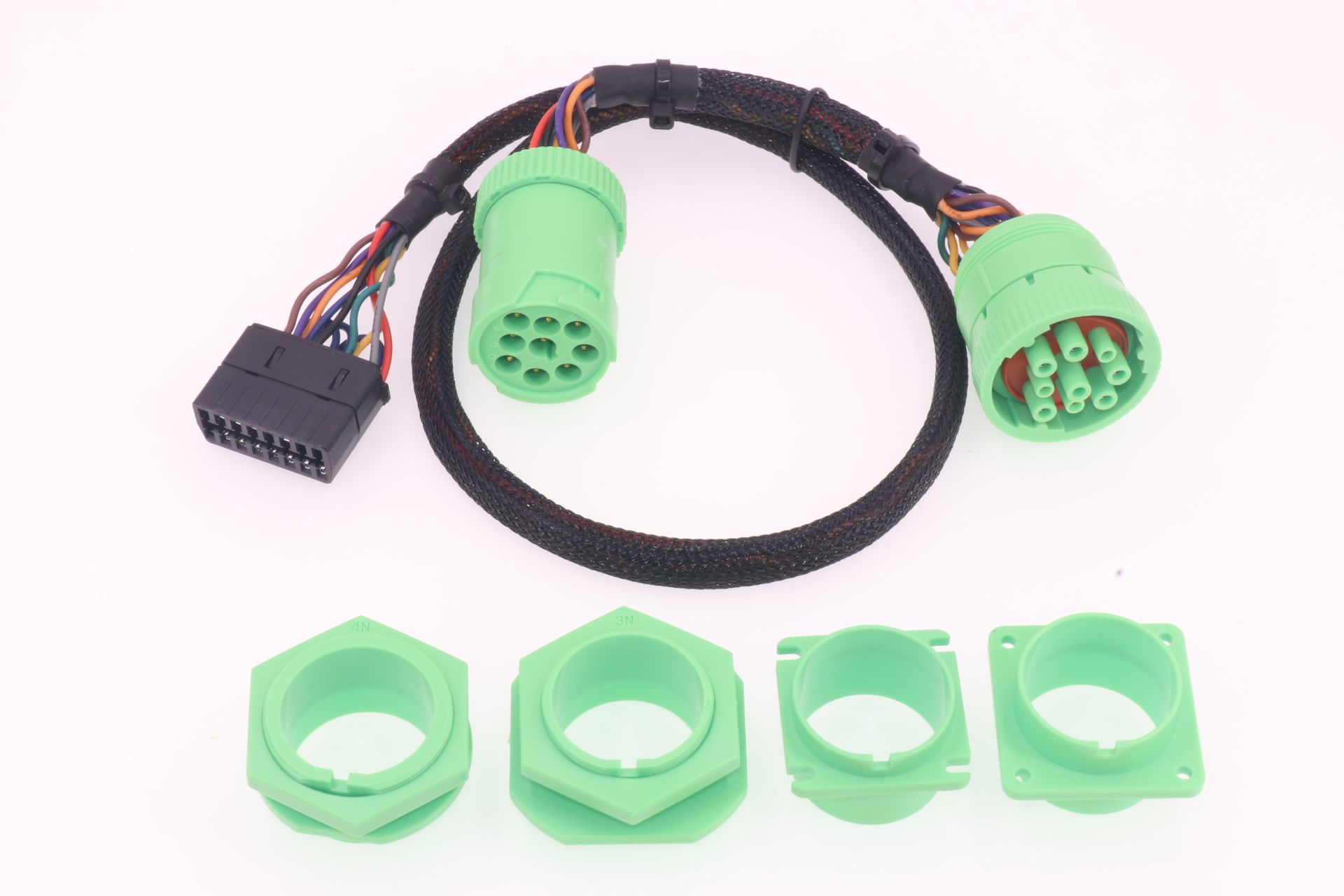 A green cable with nuts attached to it on a white surface.