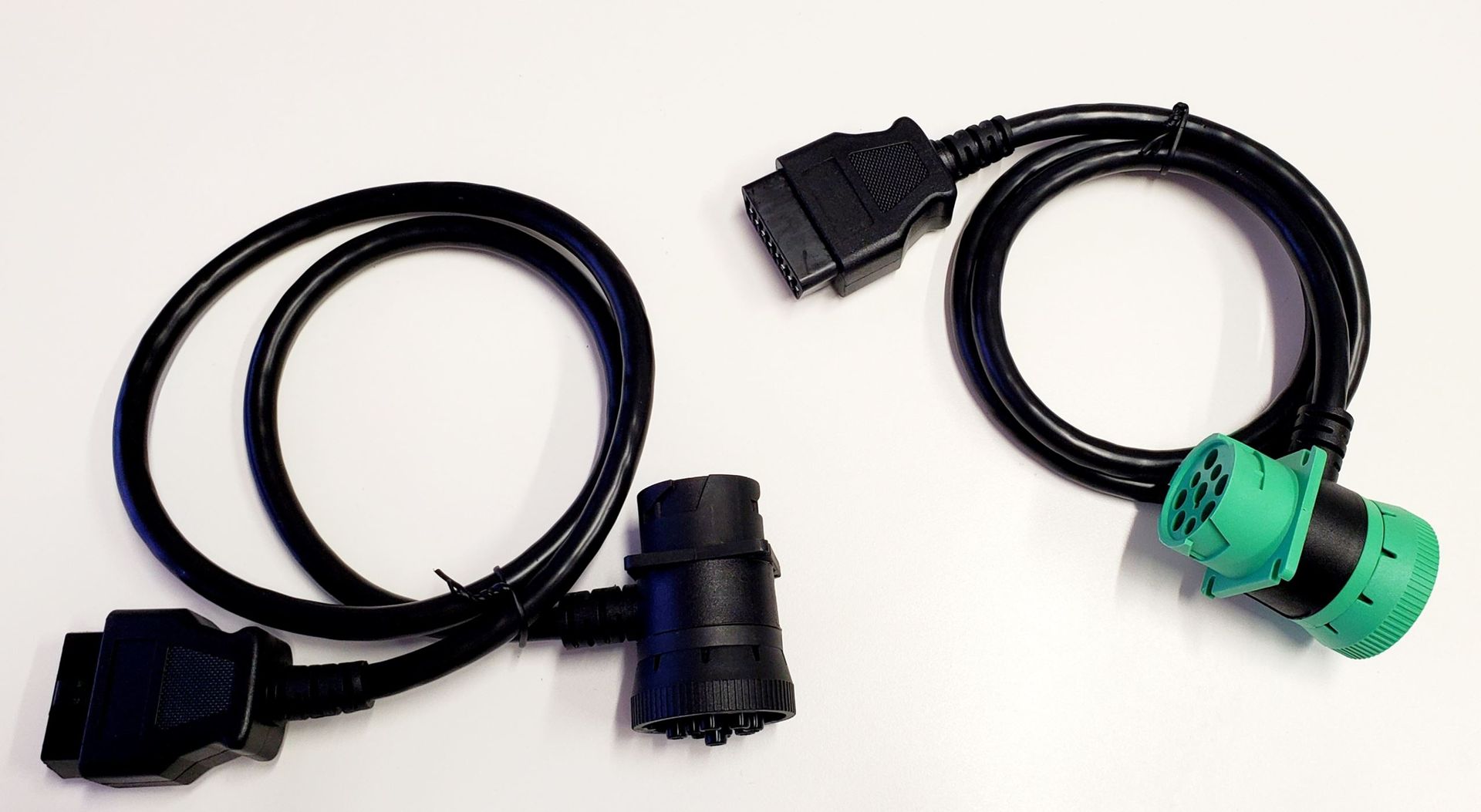 Two cables are connected to each other on a white surface