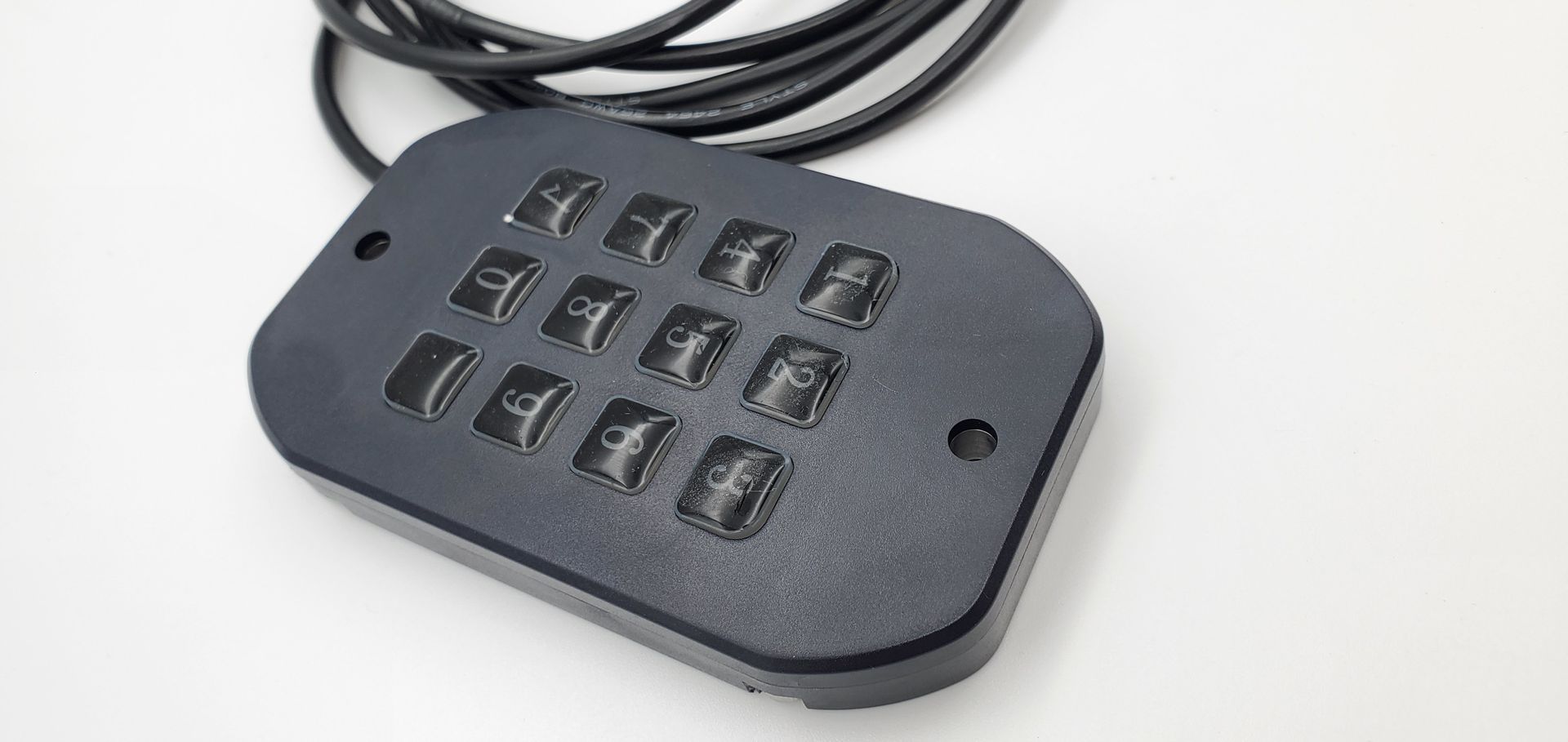 A close up of a black device with a cord attached to it.