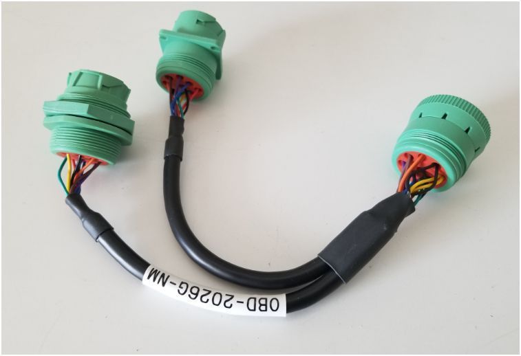 Two green connectors are attached to a black cable