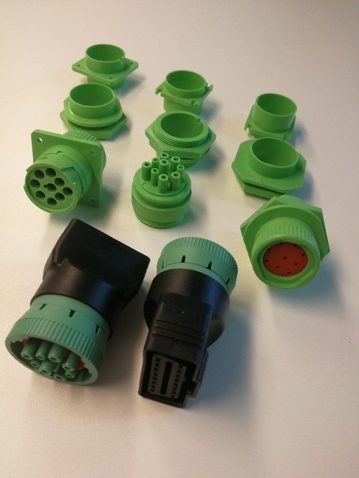 A bunch of green and black connectors on a table