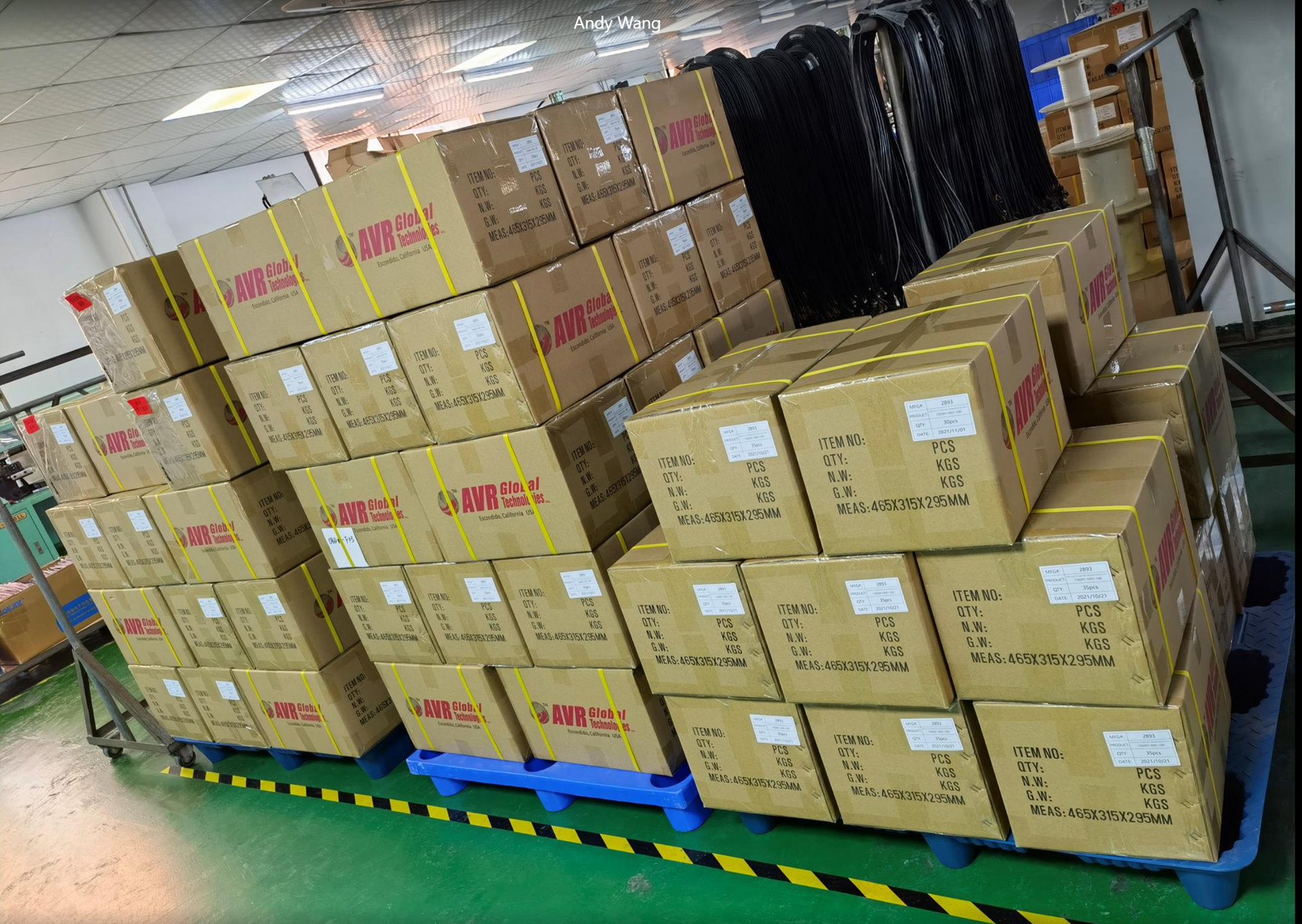 A bunch of boxes are stacked on top of each other in a warehouse.