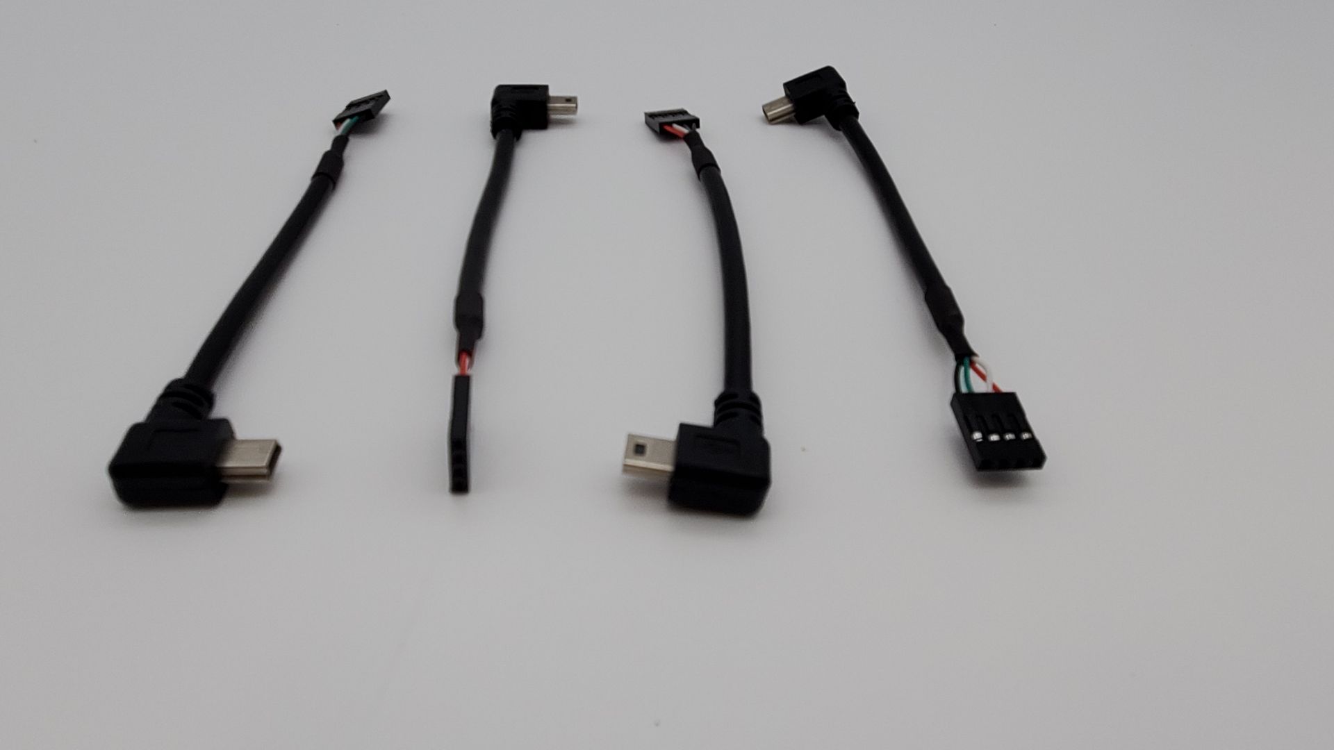 A bunch of cables are lined up on a white surface