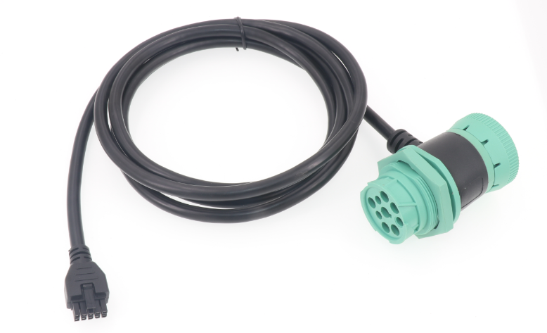A black cable with a green plug attached to it