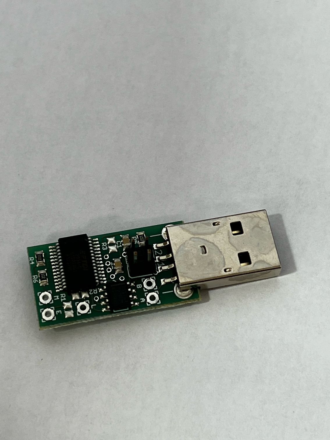 A small electronic device is sitting on a white surface.