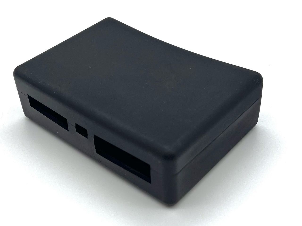A black box with two holes in it on a white surface