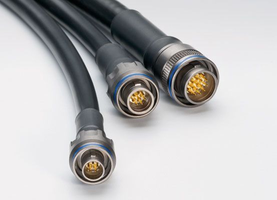 Three cables are connected to each other on a white surface.