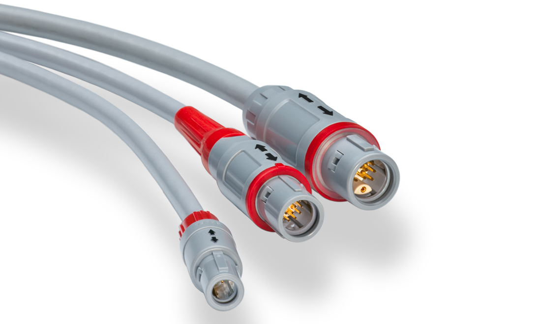 A close up of three cables with red connectors on a white background.