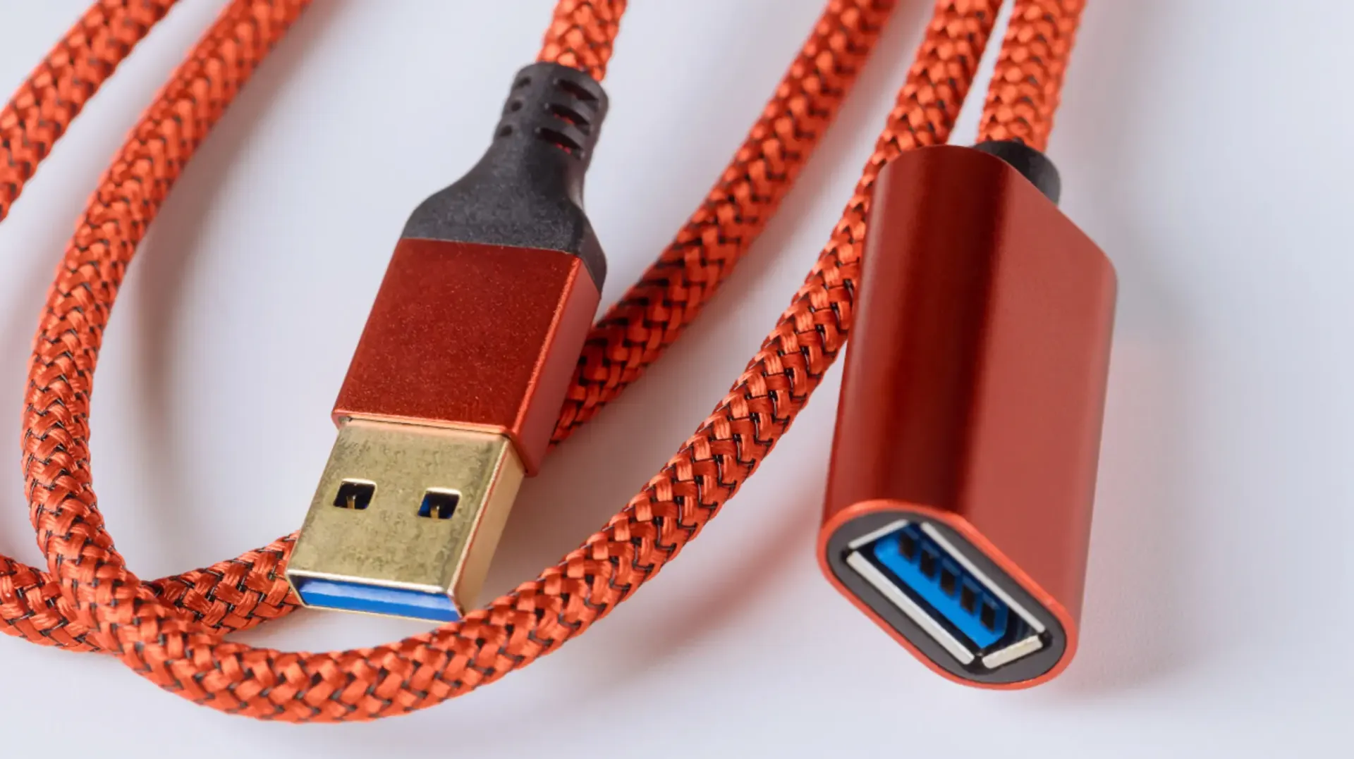 A close up of an orange usb extension cable