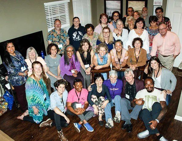 A large group of people posing for a picture in a living room