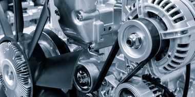 A close up of a car engine with a belt.