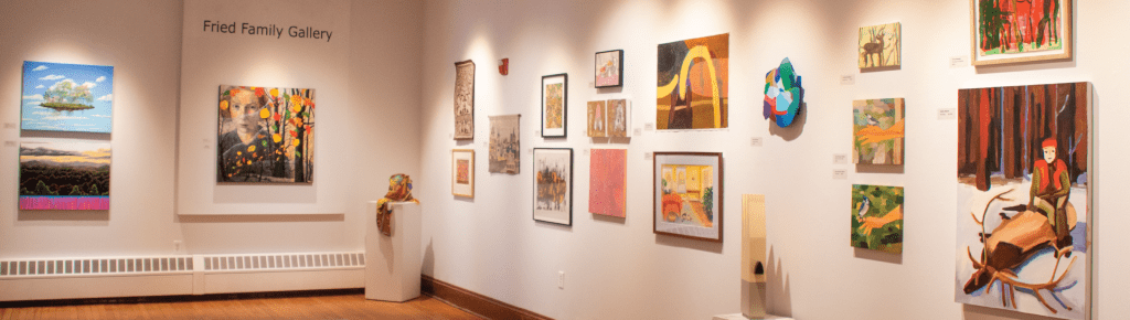 Art gallery interior with various paintings on the walls.