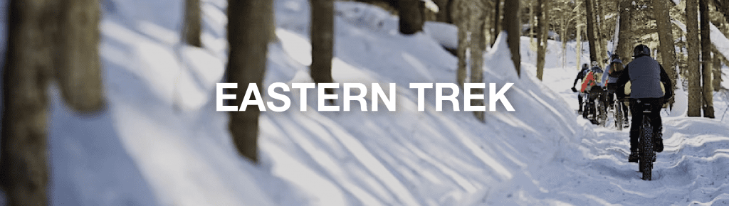 People riding bikes on a snowy trail, 