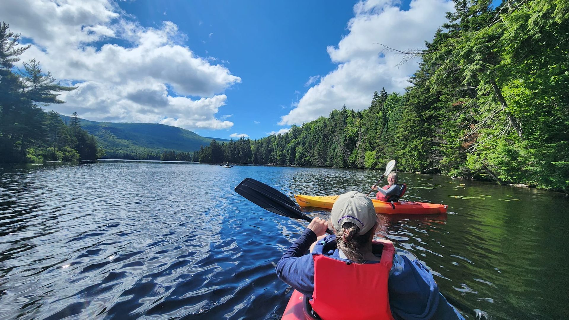 Two people kayaking in Norton Pond in Vermont's Northeast Kingdom NEK