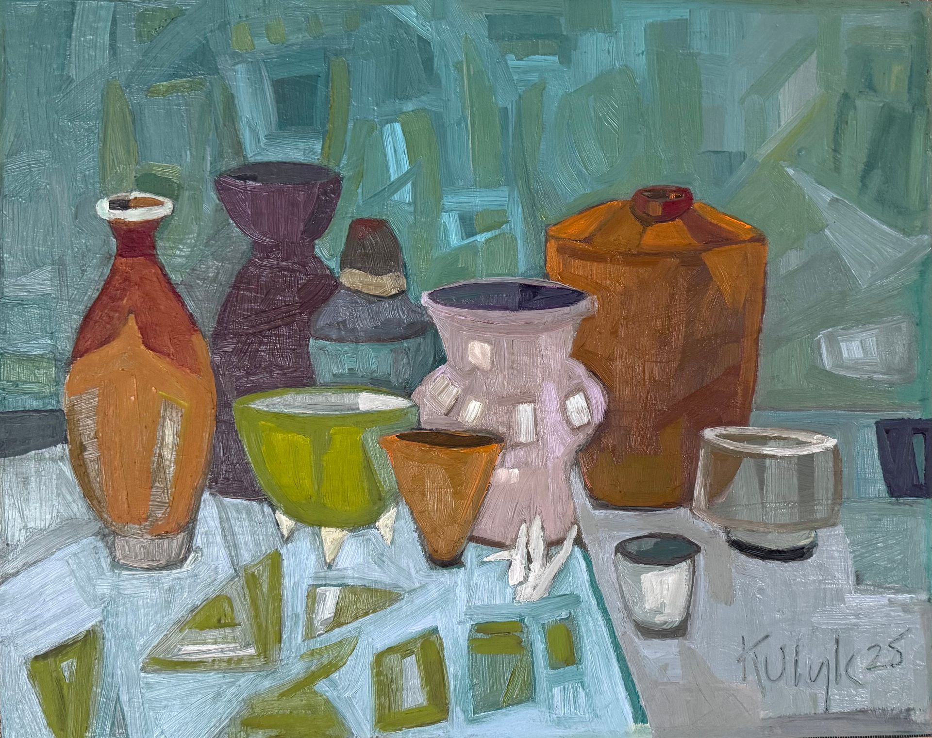 ©Karen Kulyk - Colorful garden scene with chairs, table, and umbrella surrounded by lush foliage and flowers.