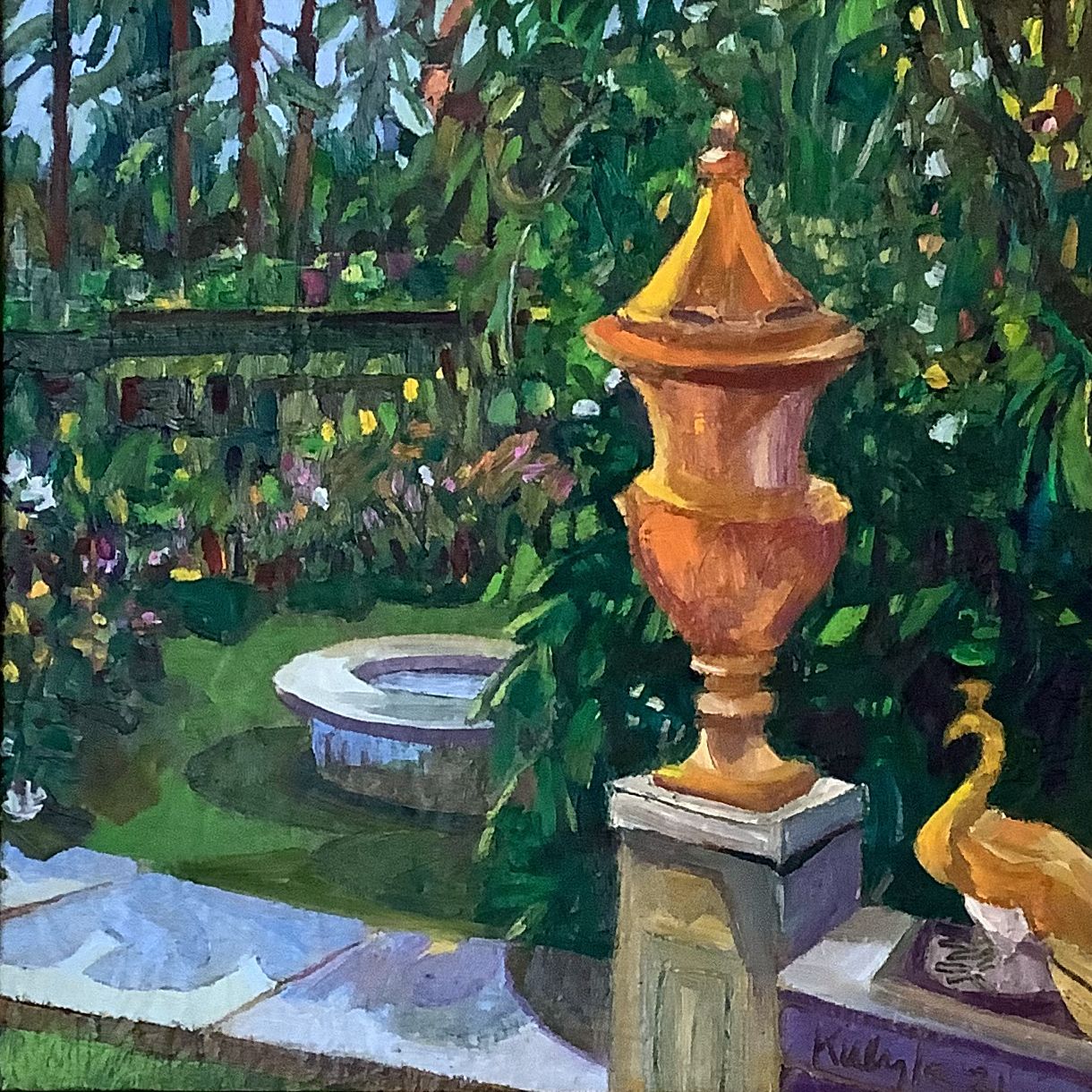©Karen Kulyk - Golden urn and peacock statue in a lush garden with a fountain.