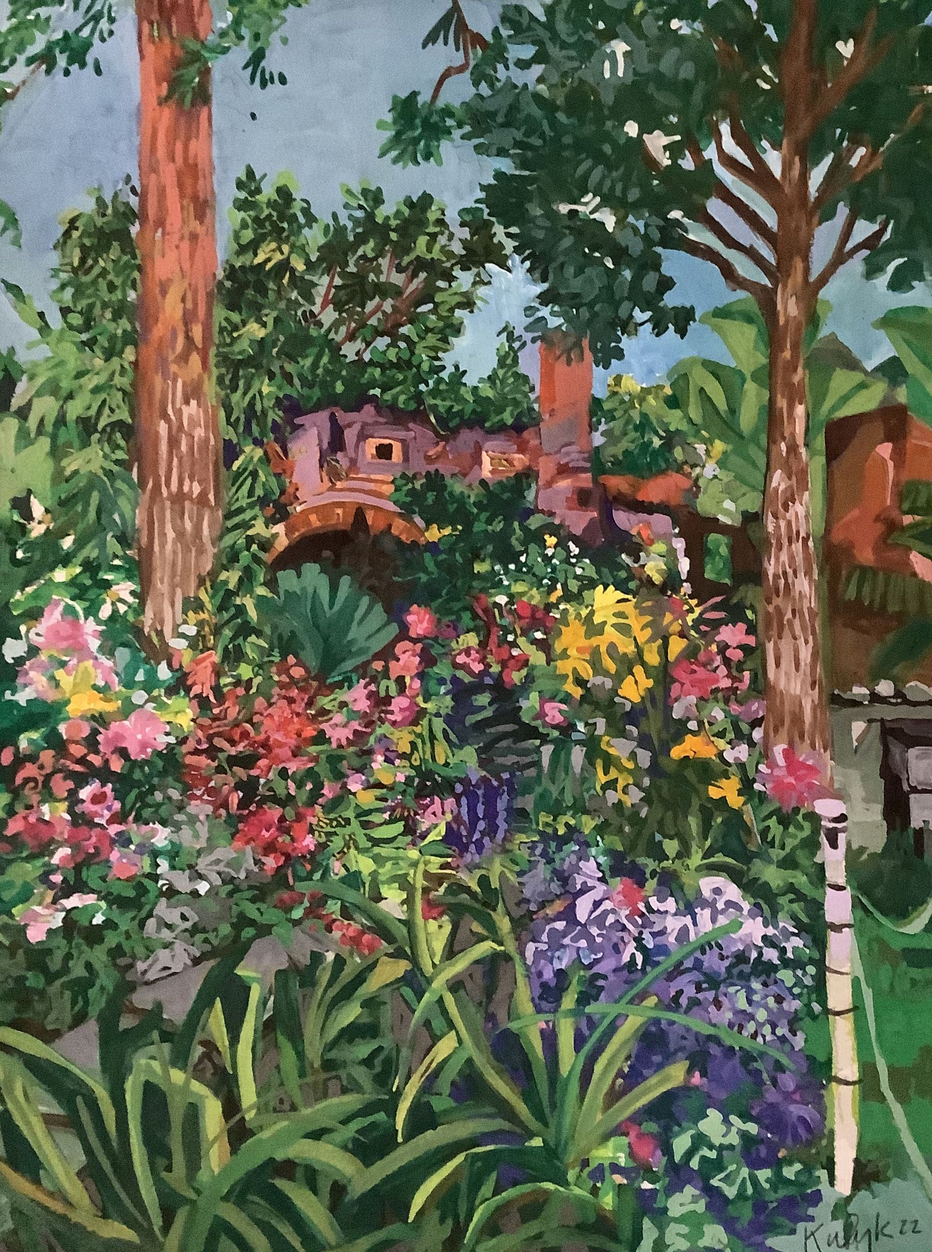 ©Karen Kulyk - Garden with colorful flowers, trees, and a weathered building in the background.