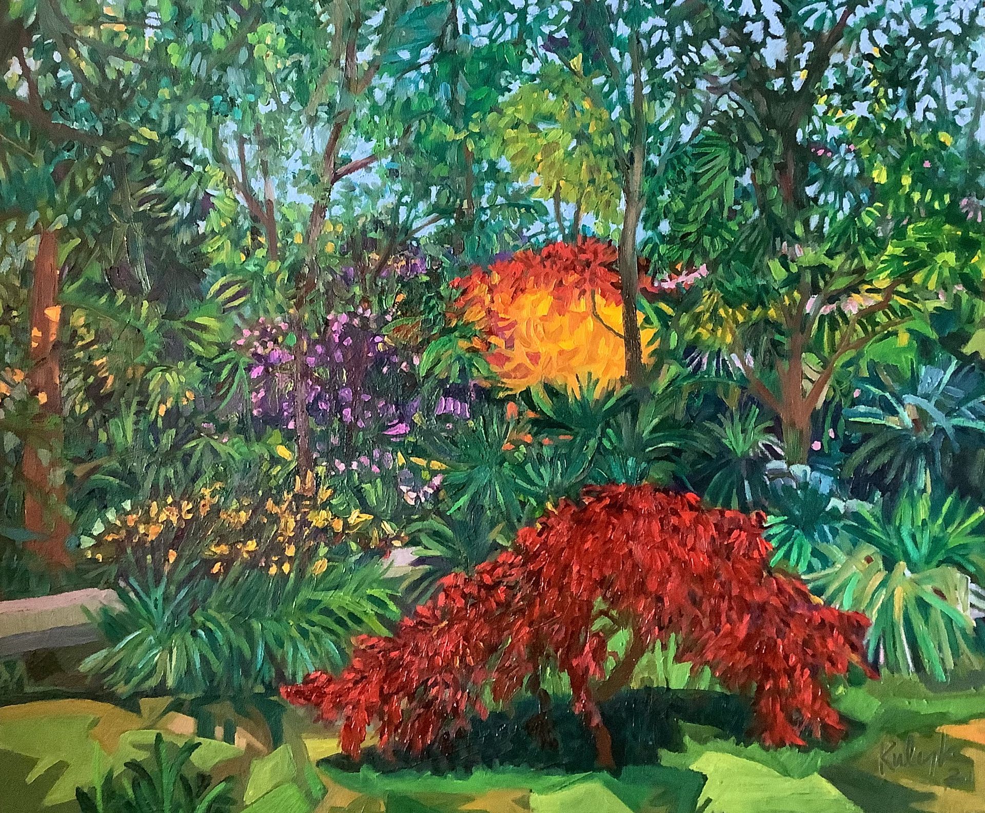 ©Karen Kulyk - Lush garden scene. Red, orange, and purple flowers among green foliage and trees.