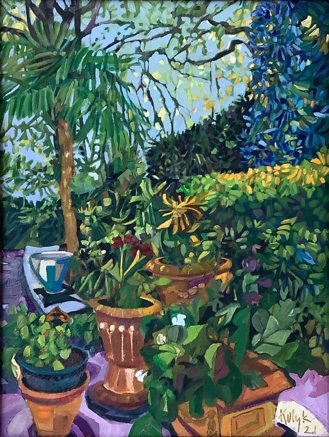 ©Karen Kulyk - A colorful garden scene with potted plants, a palm tree, and a glimpse of blue sky.