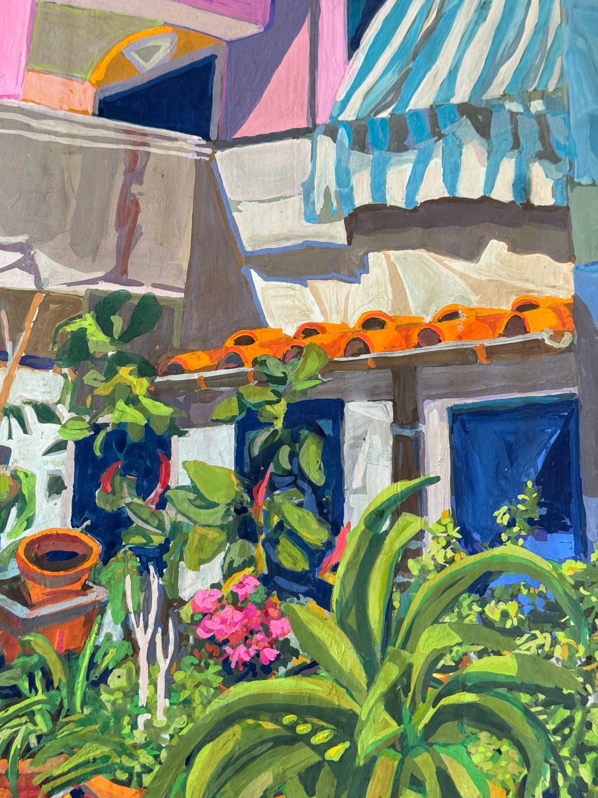 ©Karen Kulyk - Colorful Italian building with blue shutters, striped awning, and lush plants in terracotta pots.